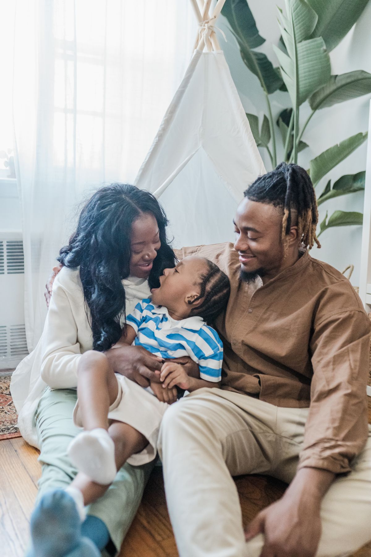 Parents spending time with their young child at home