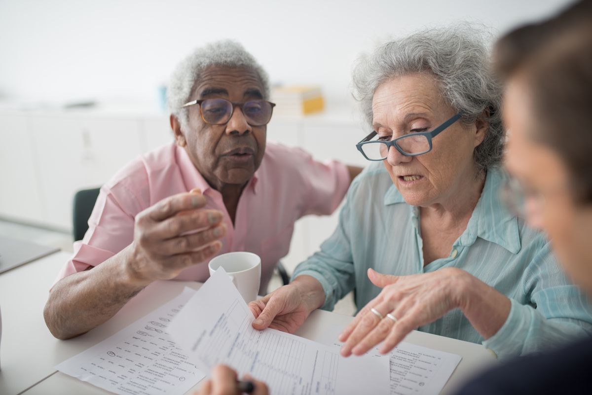 Older adults reviewing documents with a consultant